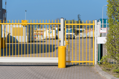 Yellow industrial security gate at a commercial site